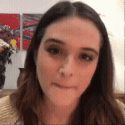 A Close Up Of A Woman 'S Face With A Blurred Background . GIF