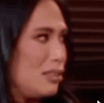 A Close Up Of A Woman 'S Face With A Blurred Background GIF