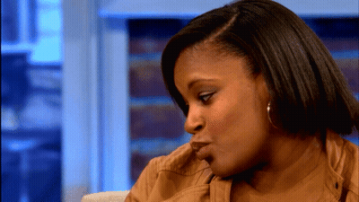 A Close Up Of A Woman 'S Face With A Blurred Background GIF