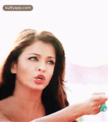 A Close Up Of A Woman 'S Face With A Blurred Background . GIF