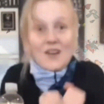 A Close Up Of A Woman 'S Face With A Blurred Background GIF