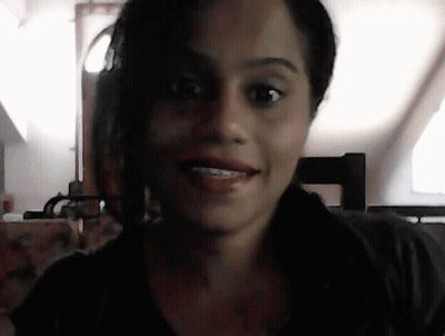 A Close Up Of A Woman 'S Face With A Blurred Background GIF