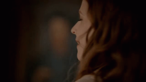 A Close Up Of A Woman 'S Face With A Blurred Background GIF