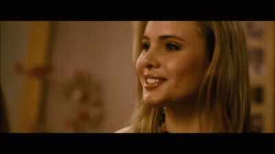 A Close Up Of A Woman 'S Face With A Blurred Background GIF