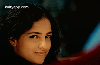 A Close Up Of A Woman 'S Face With A Blurred Background . GIF