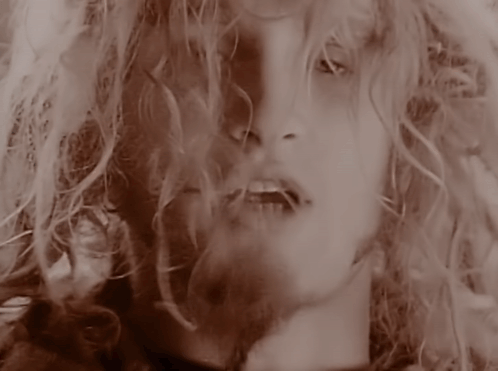 A Close Up Of A Woman 'S Face With A Blurred Background GIF