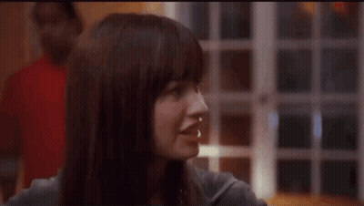 A Close Up Of A Woman 'S Face With A Blurry Background GIF