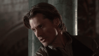A Close Up Of A Woman 'S Face With A Blurry Background Of Lights GIF