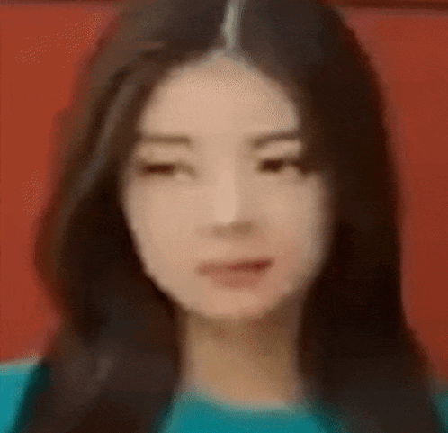 A Close Up Of A Woman 'S Face With A Blurry Background GIF