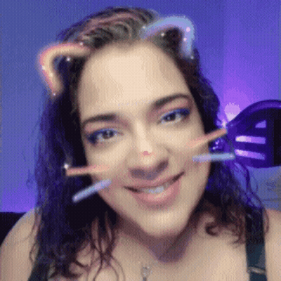 A Close Up Of A Woman 'S Face With A Cat Ear Filter On GIF