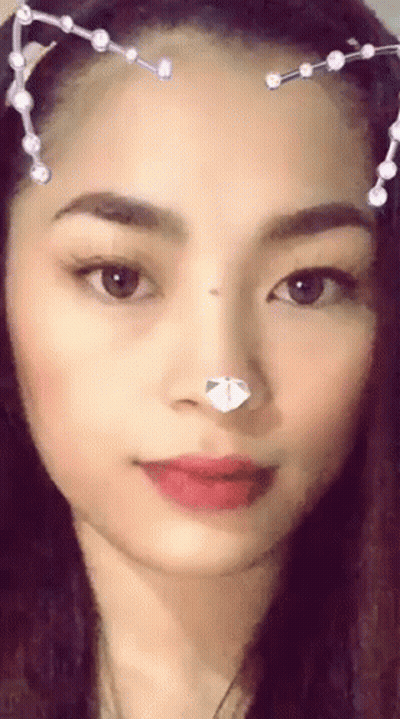 A Close Up Of A Woman 'S Face With A Cat Ear Headband . GIF