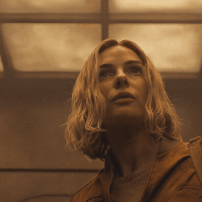 a close up of a woman 's face with a ceiling in the background