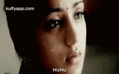 A Close Up Of A Woman 'S Face With A Crying Look On Her Face . GIF