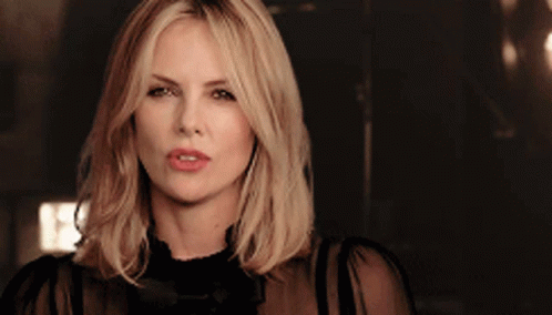 A Close Up Of A Woman 'S Face With A Dark Background GIF
