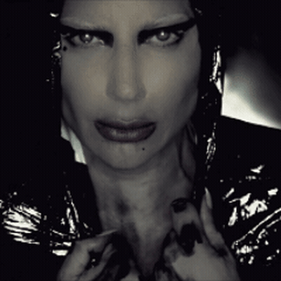 A Close Up Of A Woman 'S Face With A Dark Background GIF