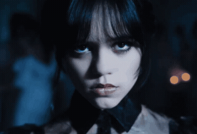 A Close Up Of A Woman 'S Face With A Dark Background GIF