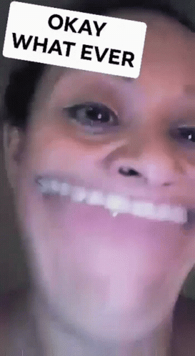 A Close Up Of A Woman 'S Face With A Filter That Says Okay What Ever On It . GIF