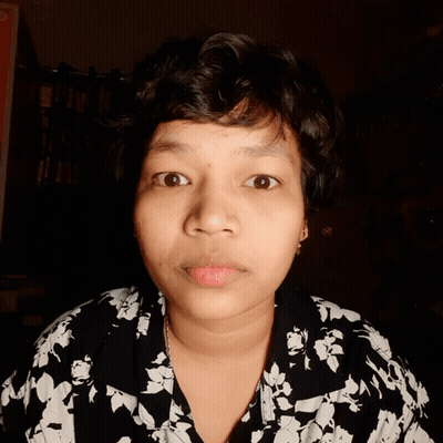 A Close Up Of A Woman 'S Face With A Floral Shirt GIF