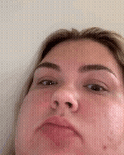 A Close Up Of A Woman 'S Face With A Funny Face . GIF