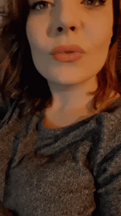 A Close Up Of A Woman 'S Face With A Gray Shirt GIF