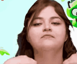 A Close Up Of A Woman 'S Face With A Green Frog In The Background . GIF