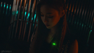 A Close Up Of A Woman 'S Face With A Green Light In Her Hair GIF