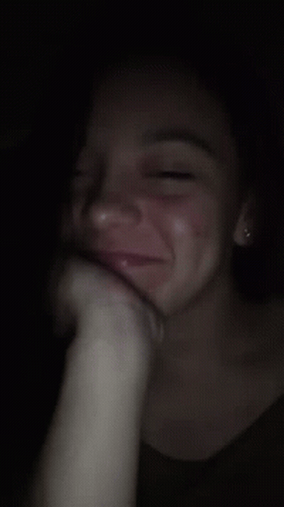 A Close Up Of A Woman 'S Face With A Hand On Her Face GIF