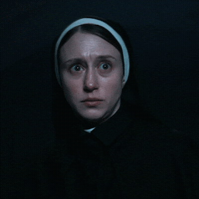 A Close Up Of A Woman 'S Face With A Headband On GIF