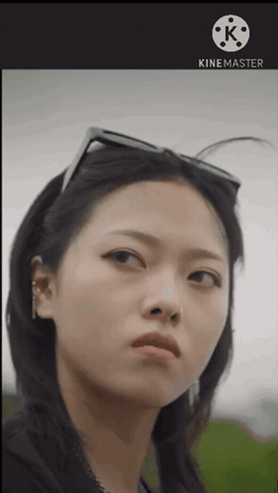 A Close Up Of A Woman 'S Face With A Kinemaster Logo Behind Her GIF