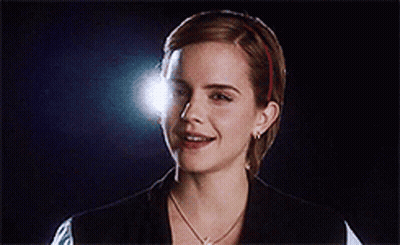A Close Up Of A Woman 'S Face With A Light Shining On Her Face GIF