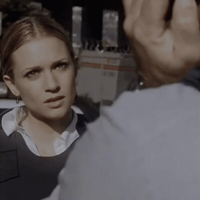 A Close Up Of A Woman 'S Face With A Man 'S Hand Behind Her GIF