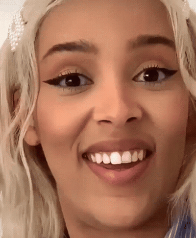 A Close Up Of A Woman 'S Face With A Missing Tooth GIF