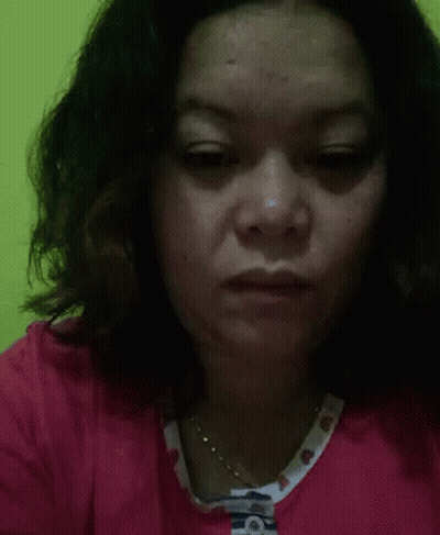 A Close Up Of A Woman 'S Face With A Necklace Around Her Neck . GIF