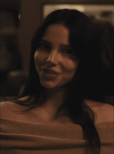 A Close Up Of A Woman 'S Face With A Necklace On GIF