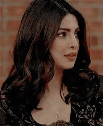 A Close Up Of A Woman 'S Face With A Necklace On . GIF