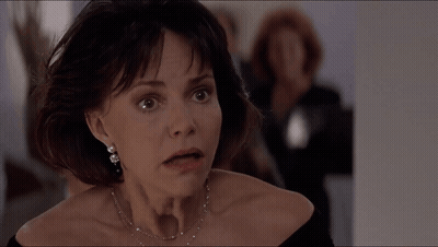 A Close Up Of A Woman 'S Face With A Necklace On GIF