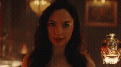 A Close Up Of A Woman 'S Face With A Necklace On . GIF