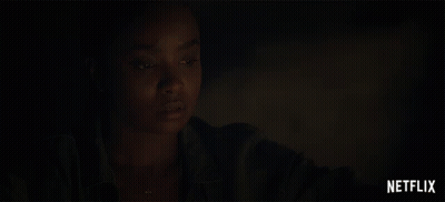 A Close Up Of A Woman 'S Face With A Netflix Logo Behind Her GIF