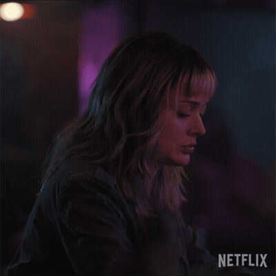 A Close Up Of A Woman 'S Face With A Netflix Logo Behind Her GIF