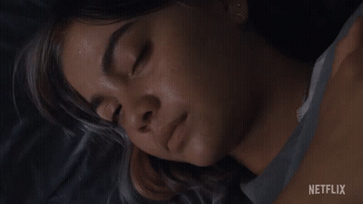 A Close Up Of A Woman 'S Face With A Netflix Logo In The Corner GIF