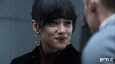 A Close Up Of A Woman 'S Face With A Netflix Logo On The Bottom GIF