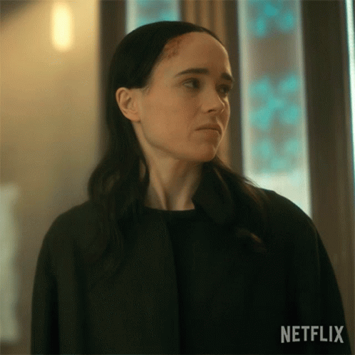A Close Up Of A Woman 'S Face With A Netflix Logo On The Bottom GIF
