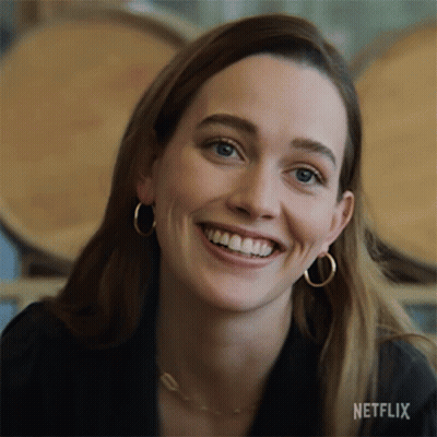 A Close Up Of A Woman 'S Face With A Netflix Logo On The Bottom GIF