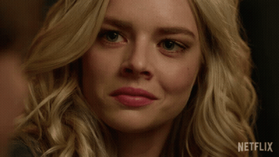 A Close Up Of A Woman 'S Face With A Netflix Logo On The Bottom GIF
