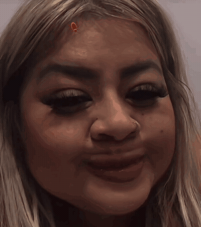 A Close Up Of A Woman 'S Face With A Nose Piercing GIF