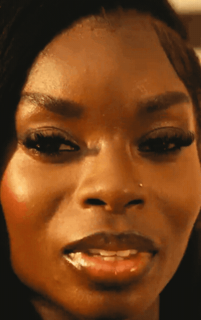 A Close Up Of A Woman 'S Face With A Nose Piercing GIF