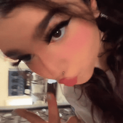 A Close Up Of A Woman 'S Face With A Nose Ring GIF