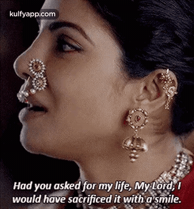 A Close Up Of A Woman 'S Face With A Nose Ring And Earrings And A Quote . GIF