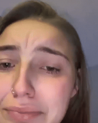 A Close Up Of A Woman 'S Face With A Nose Ring On It . GIF