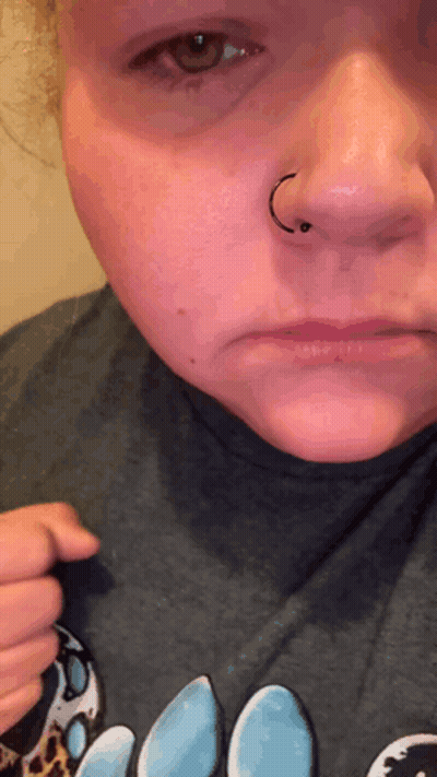 A Close Up Of A Woman 'S Face With A Nose Ring On It GIF